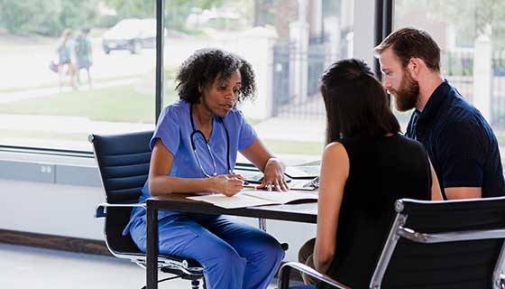Couple speaking with their neurosurgeon