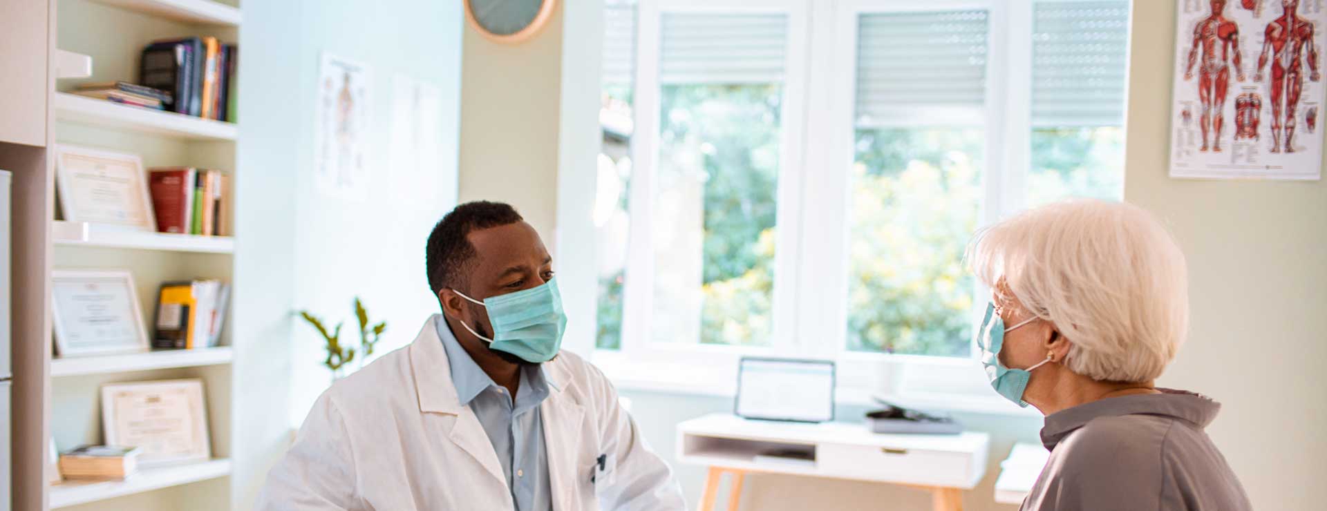 Surgeon speaking with a patient in a sunny room