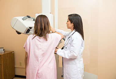 A woman getting a mammogram