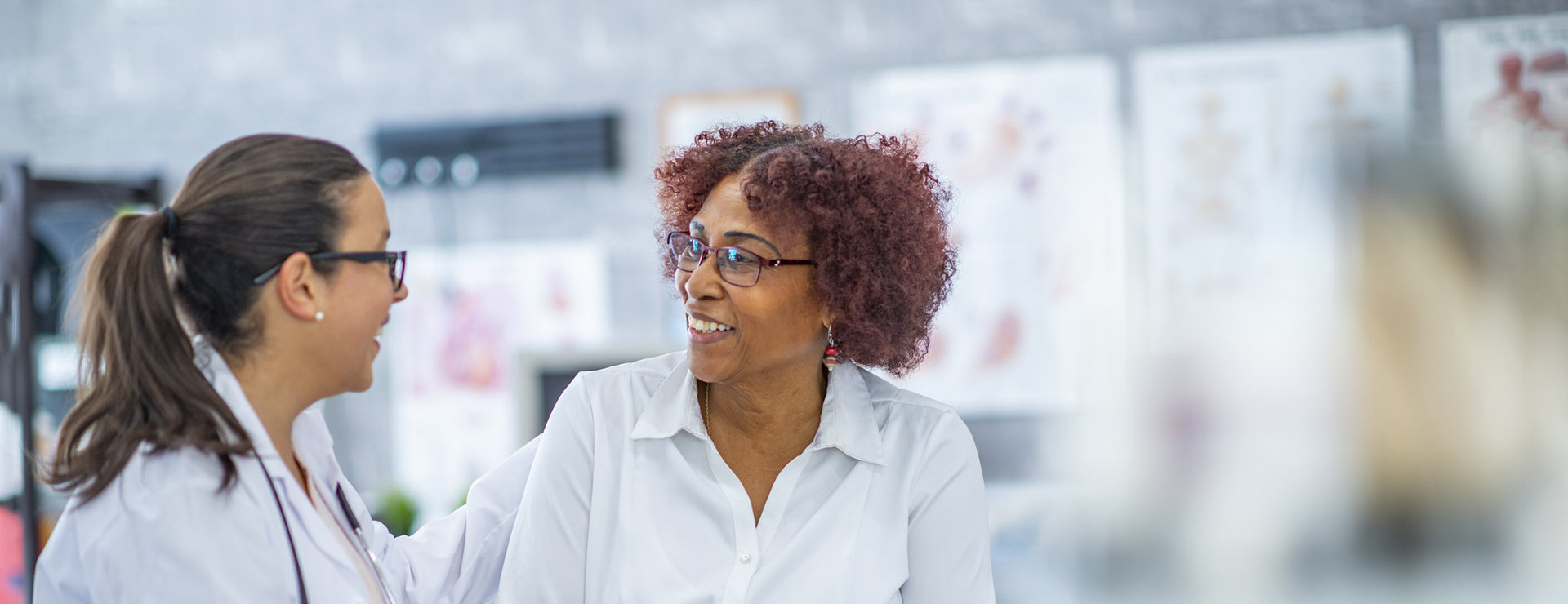 A middle-aged Black woman sits with her female doctor to discuss mastectomy options.