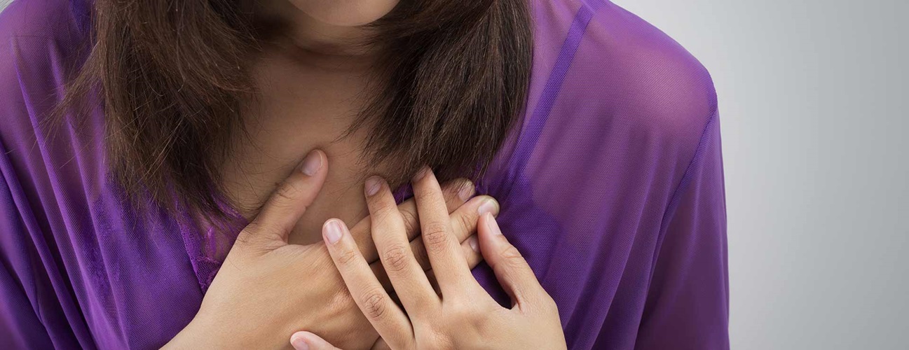 A woman experiences pain in her breast.
