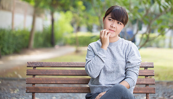Woman scratches at mouth