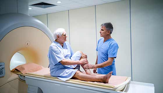 a man prepares to undergo a medical scan