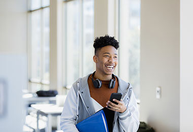 teen boy with phone at school