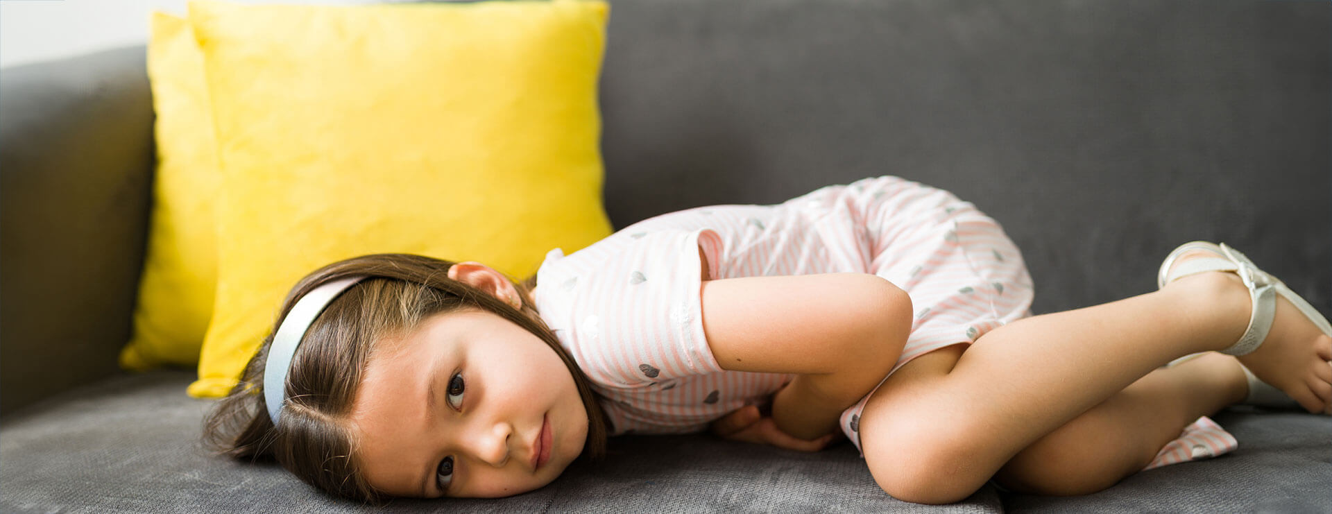 A child lies on a couch as she prepares for an appendectomy for children.
