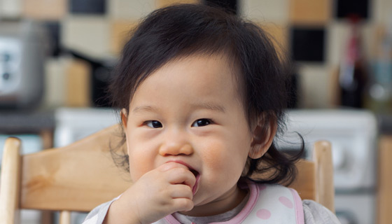 Baby girl sucking on her fingers