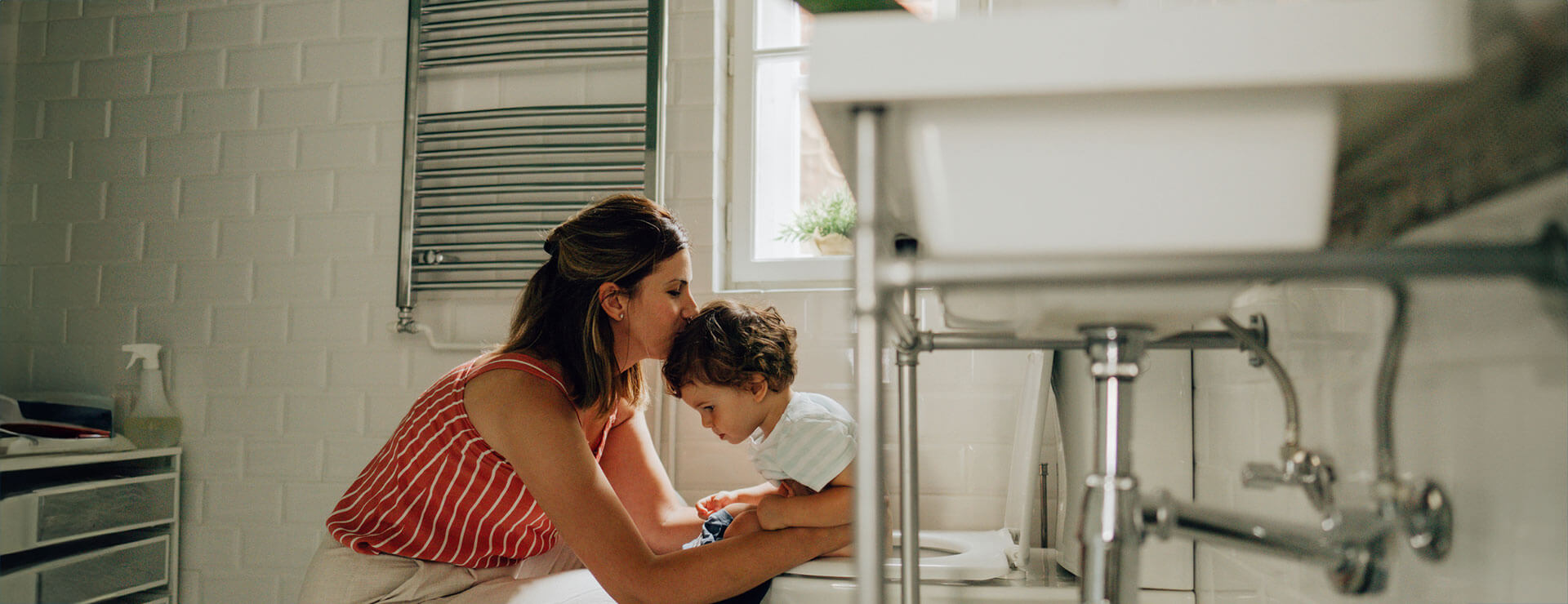 A mother helps a child through diarrhea in children