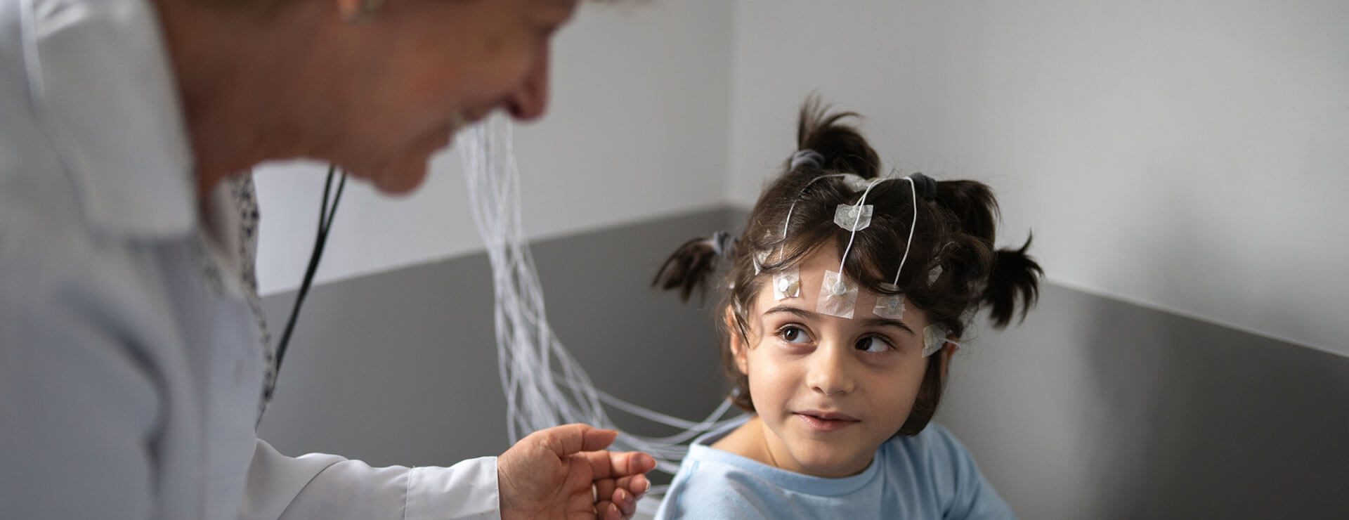 Young child listening to doctor during EEG test