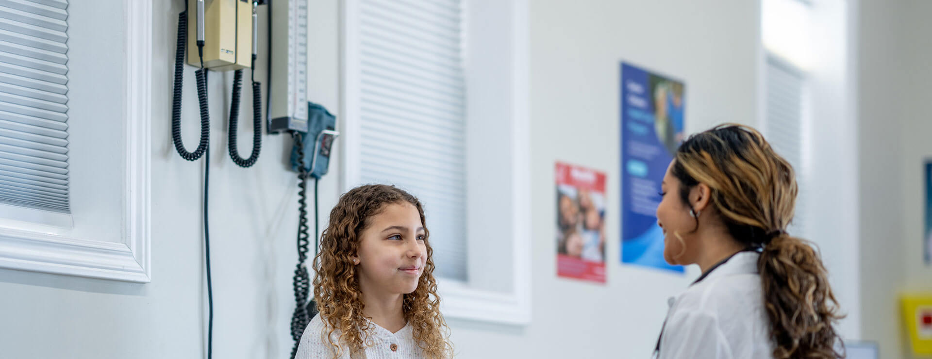 a doctor and child discuss fibromyalgia in children
