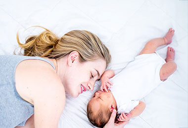A mother comforts a baby suffering from hypocemia in children