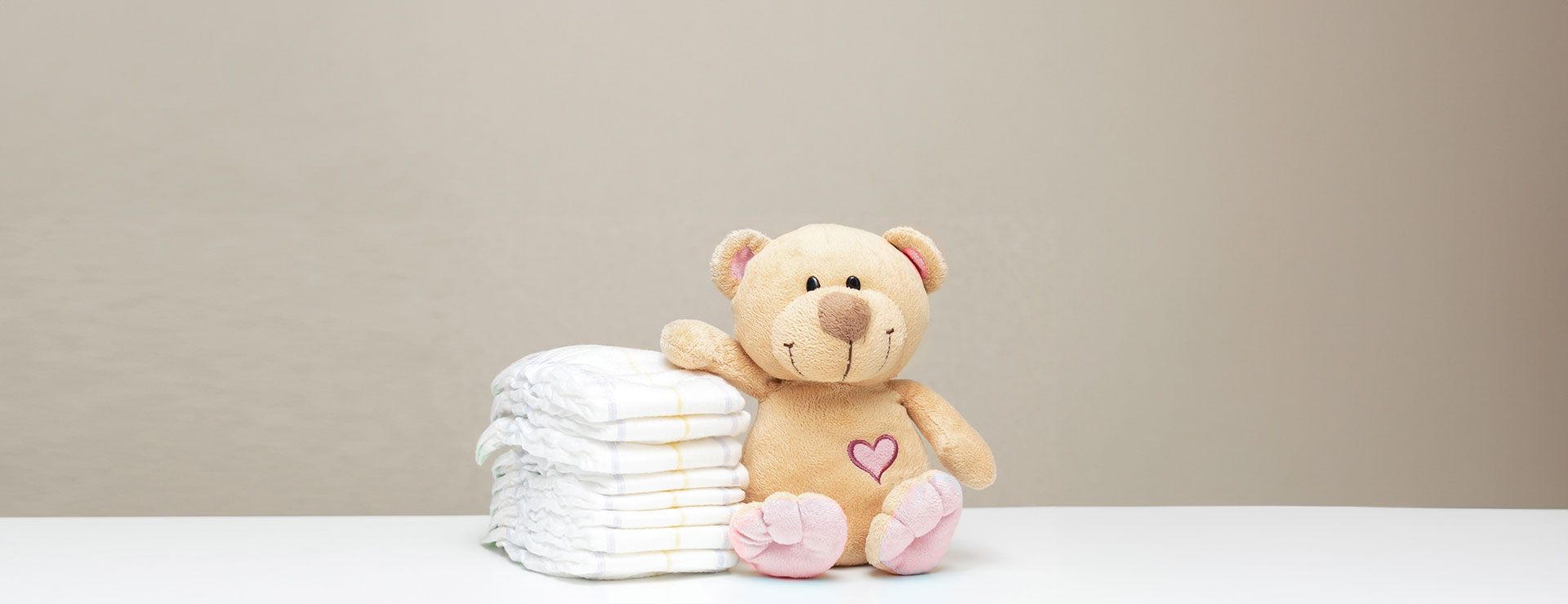 teddy bear next to diapers