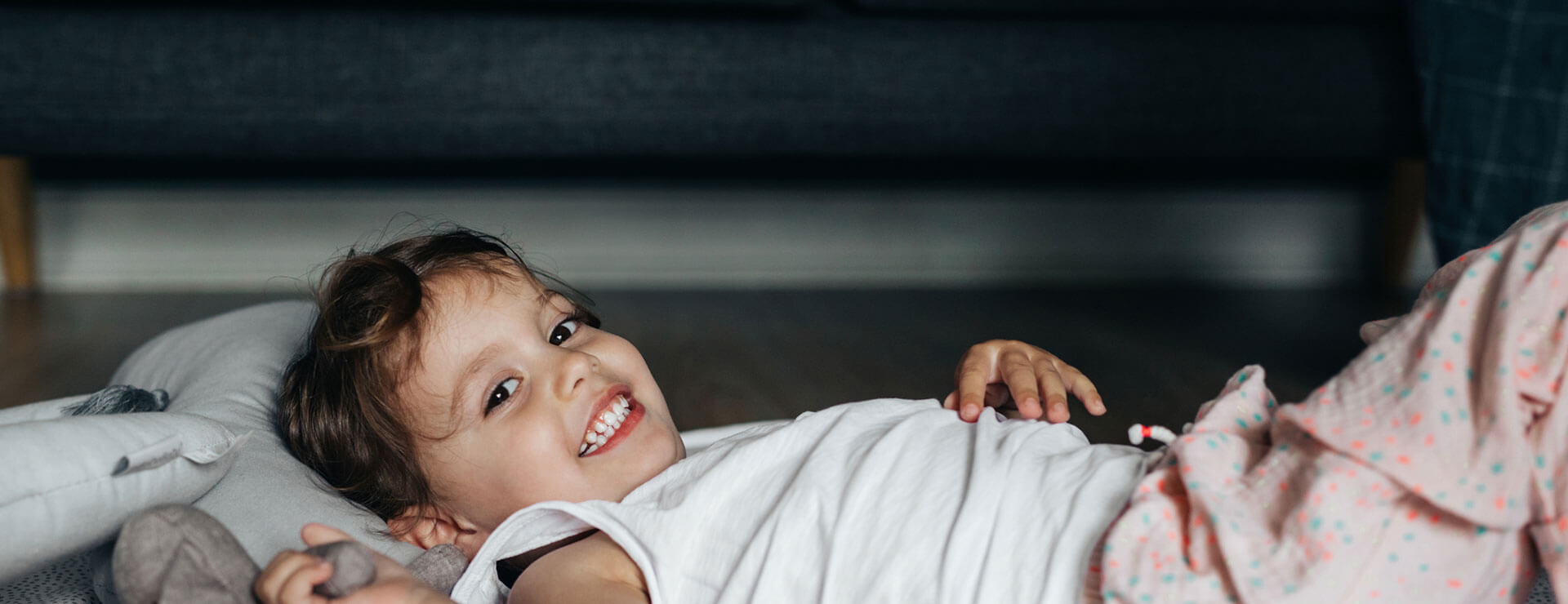 a little girl lying on a couch