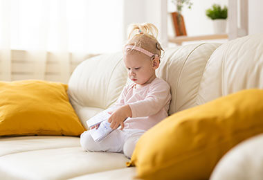 A child with usher syndrome plays on the couch