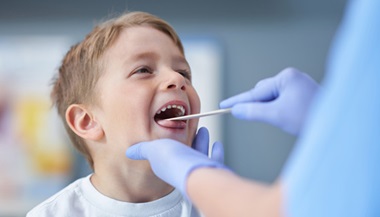 Young boy getting his mouth and teeth examined