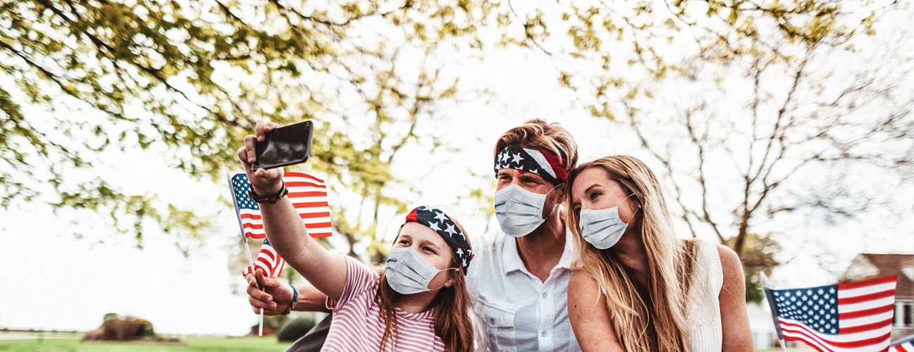 A family celebrating the 4th of July with masks on