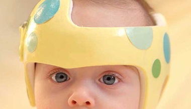 baby wearing yellow helmet