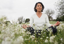 Woman meditating in a field 