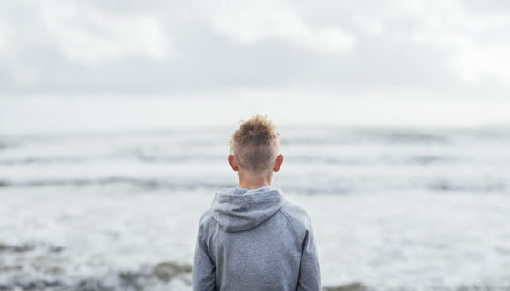 teen looks out on the water