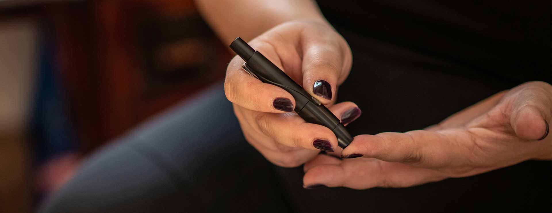 Woman measuring her blood sugar level.