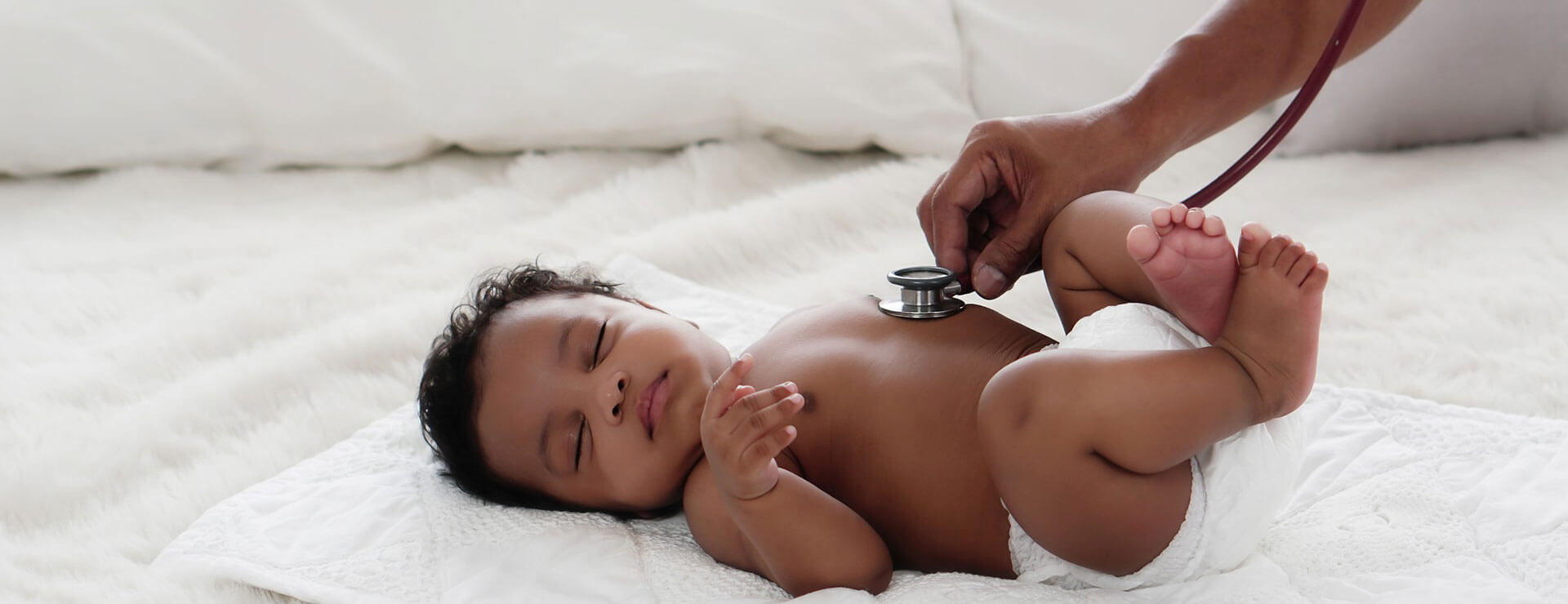 baby getting checked by doctor