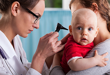 doctor examining baby's ear