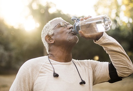 senior male drinking water