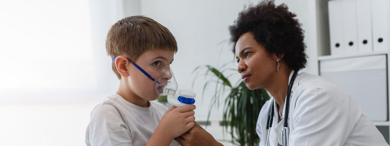doctor assisting pediatric patient with oxygen mask
