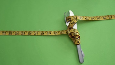 measuring tape wrapped around knife and fork