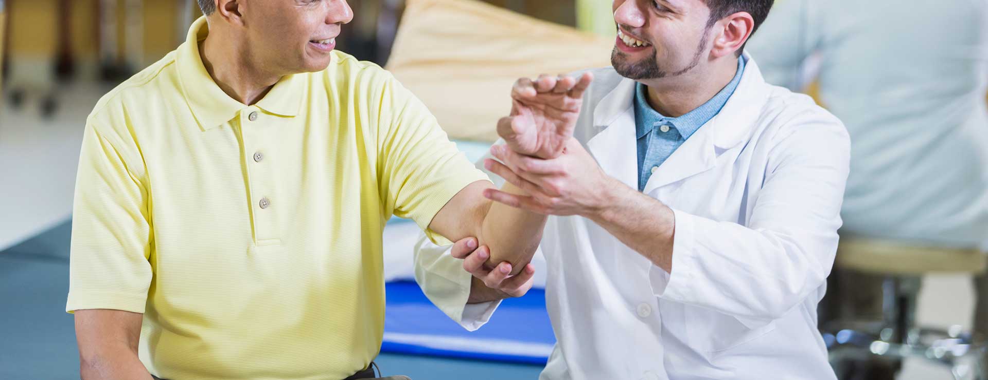 Doctor examining a patient's elbow