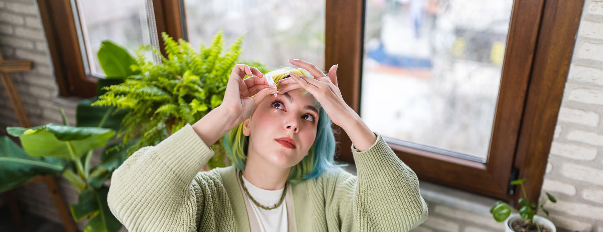 young woman puts in eye drops