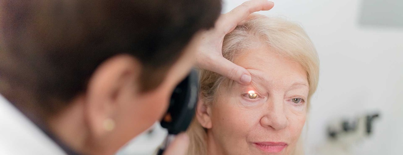 senior women having eye looked at by doctor