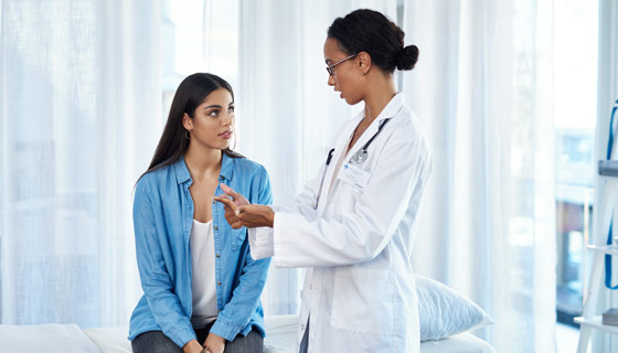 Doctor meeting with young woman patient