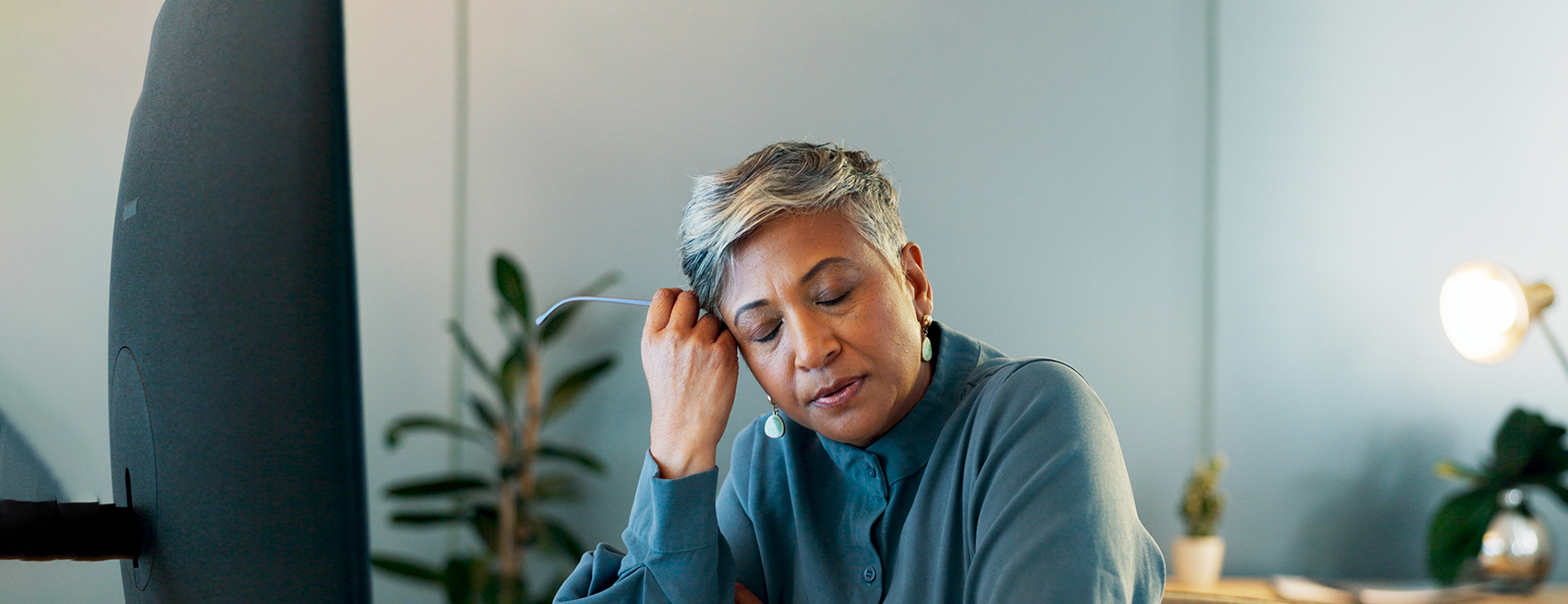 A woman tired at her desk