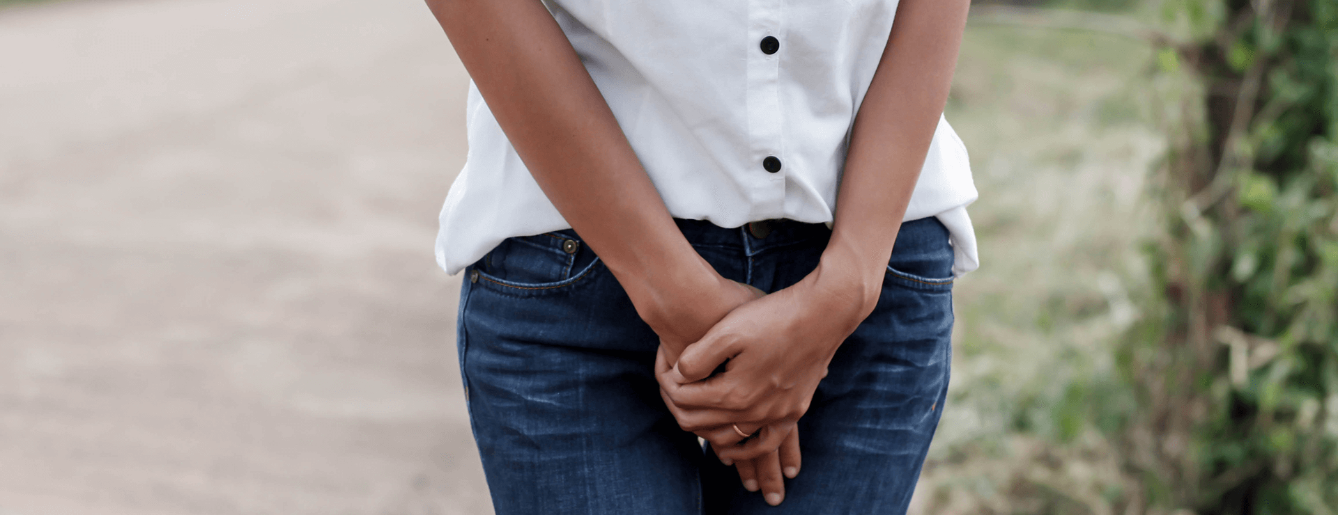 woman holds hands over pelvis