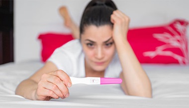 woman holds negative pregnancy test