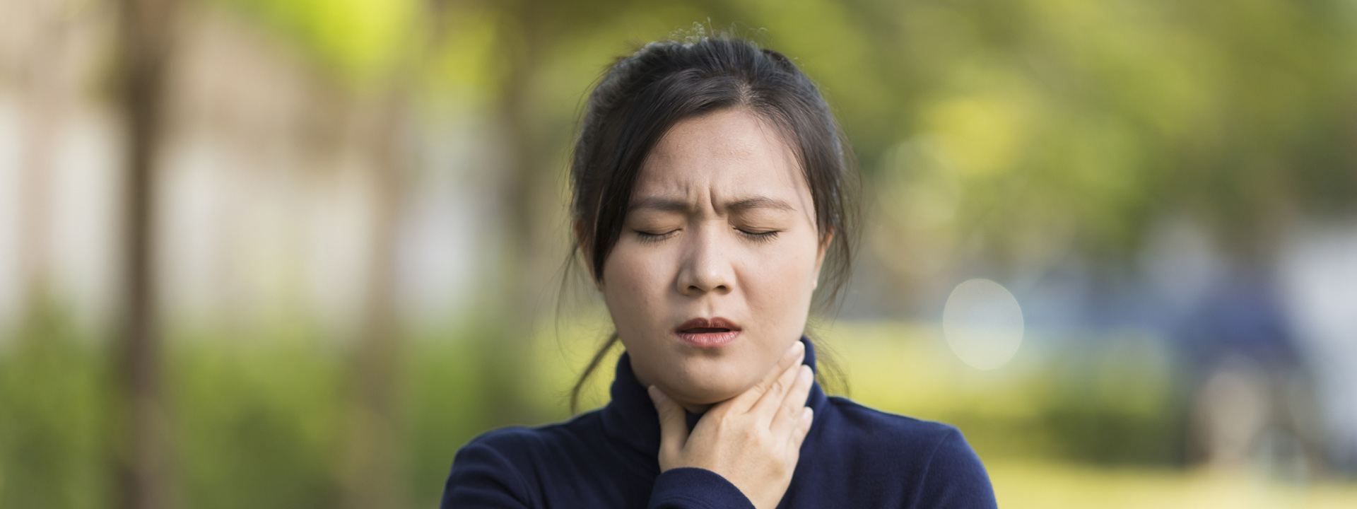 woman touching her neck