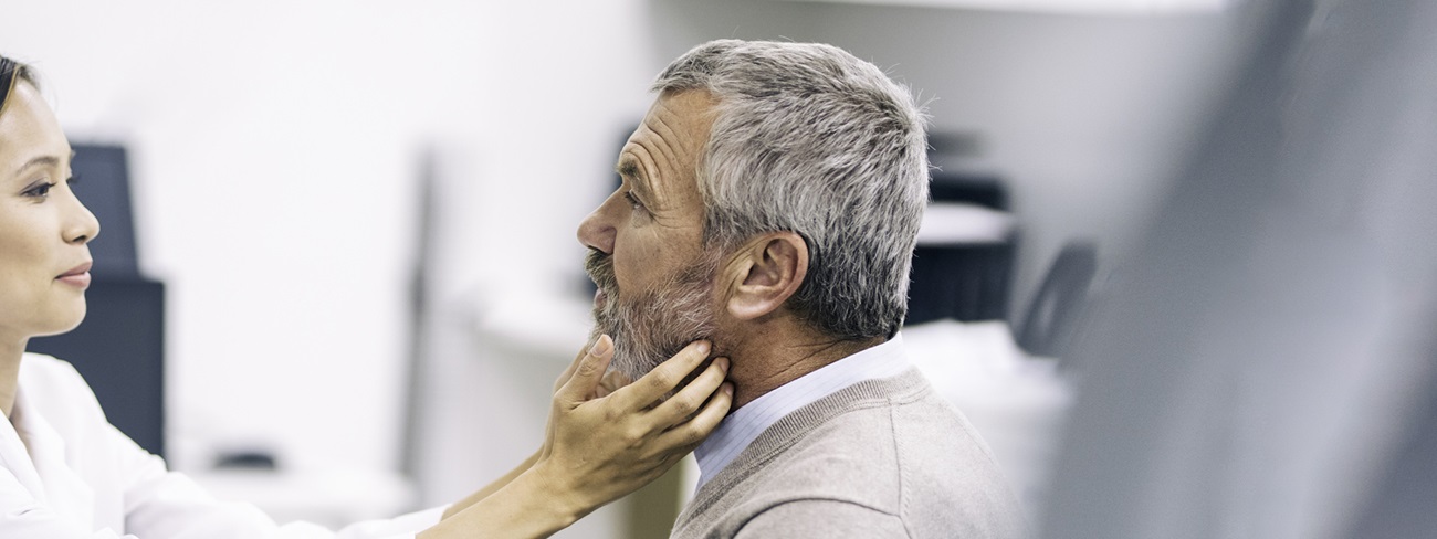 doctor checking patient's neck