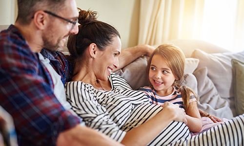 adult congenital heart disease center - couple sitting on couch with daughter