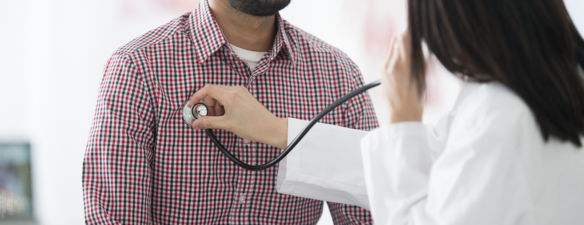 closeup of doctor listening to patient's chest - cardiac sarcoidosis