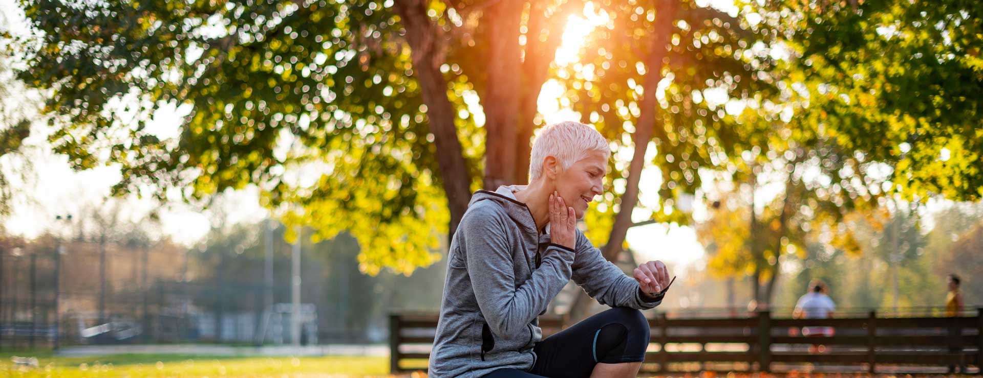 lady kneeling while checking pulse at carotid artery