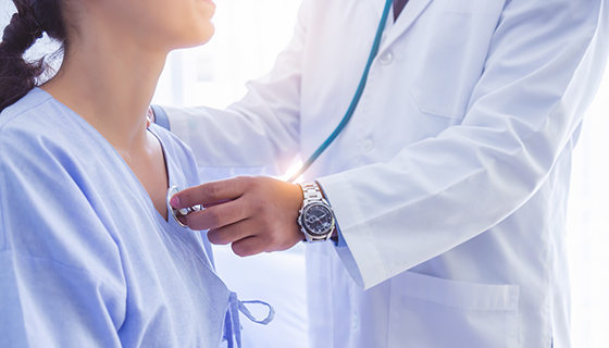tetratology of fallot in adults - doctor listening to female patient's chest