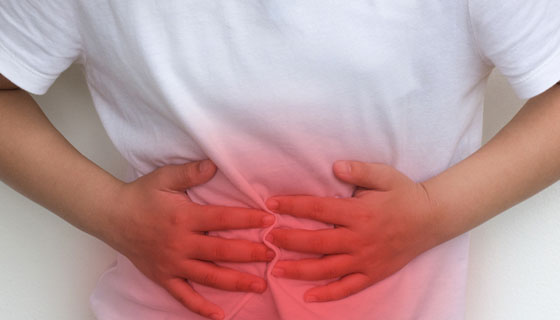 small girl holds her stomach