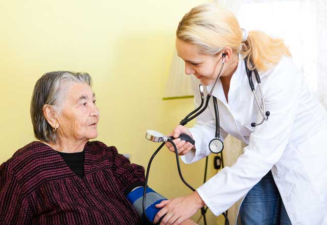 doctor checking blood pressure of patient