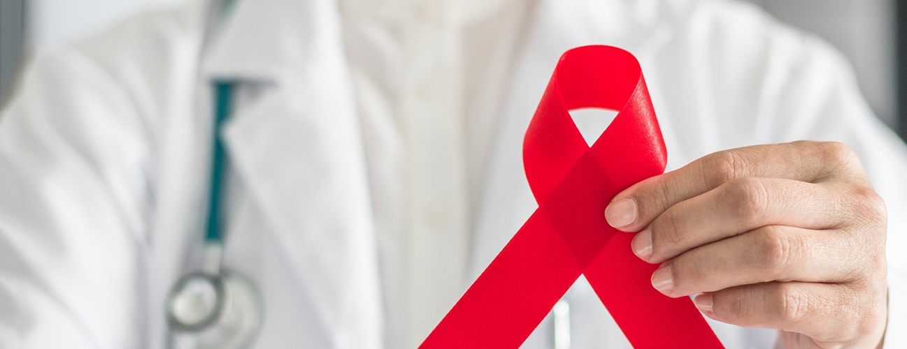 Doctor holding up HIV/AIDs awareness ribbon