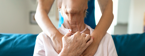 caregiver hugging senior patient