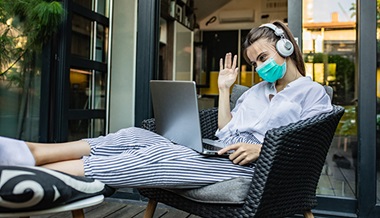 covid 19 prevention organ transplant - woman wearing mask using laptop