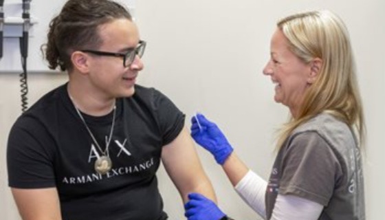 A teenage boy is getting vaccinated at Johns Hopkins All Children's Hospital against meningitis for college