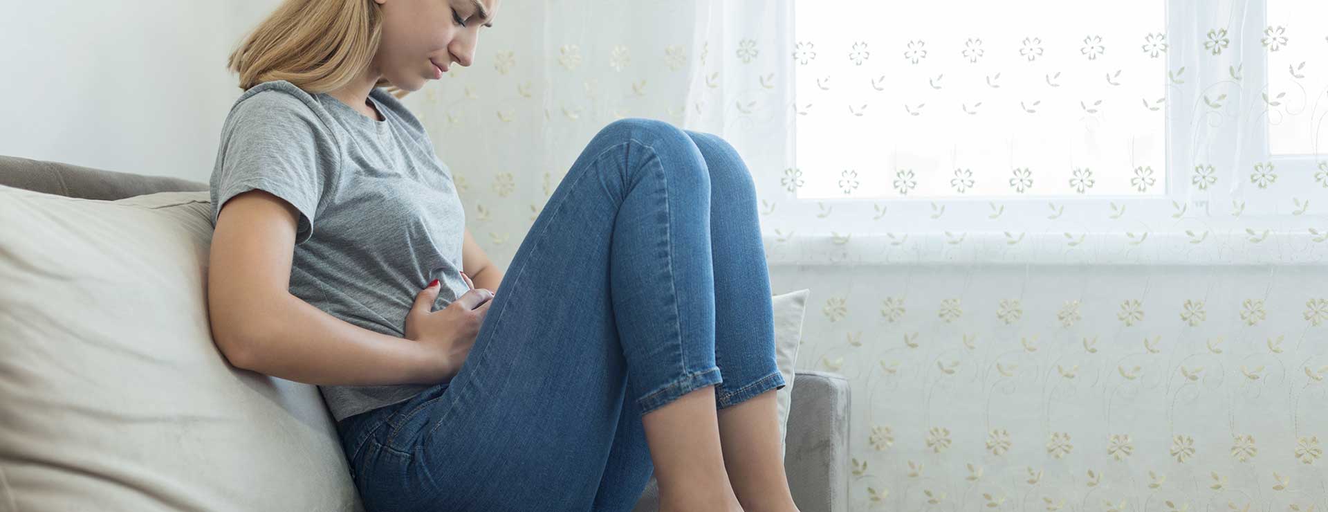 Woman experiencing severe stomach pain.