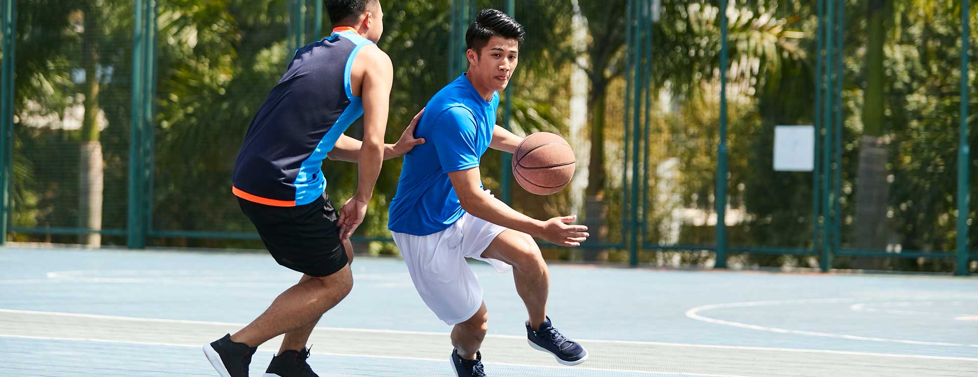Two men playing basketball on a court