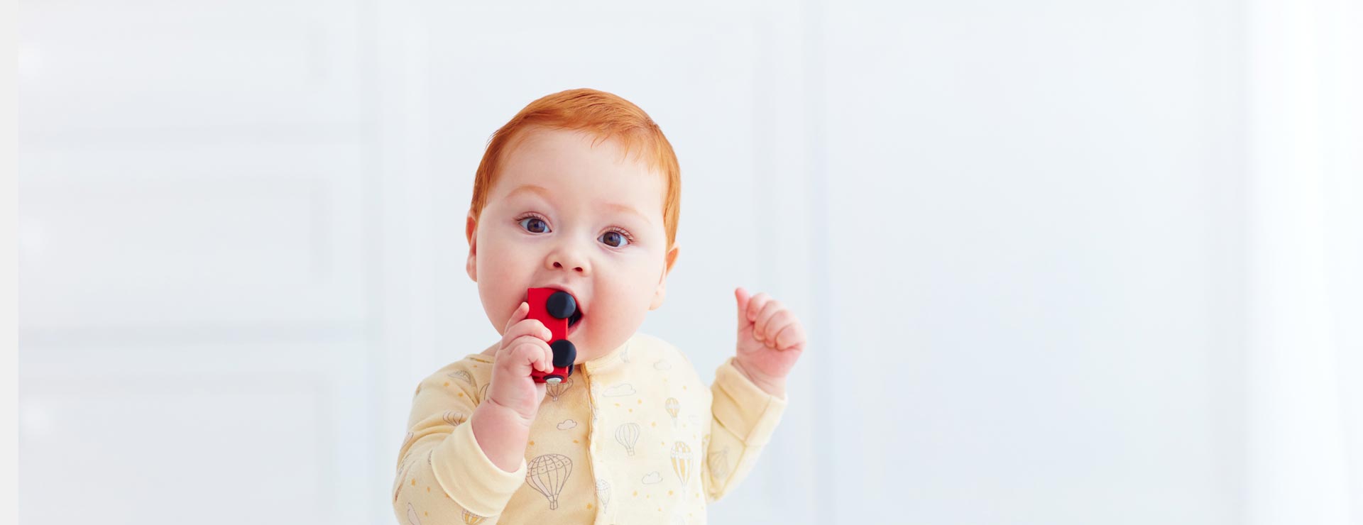 Baby with a toy in their mouth